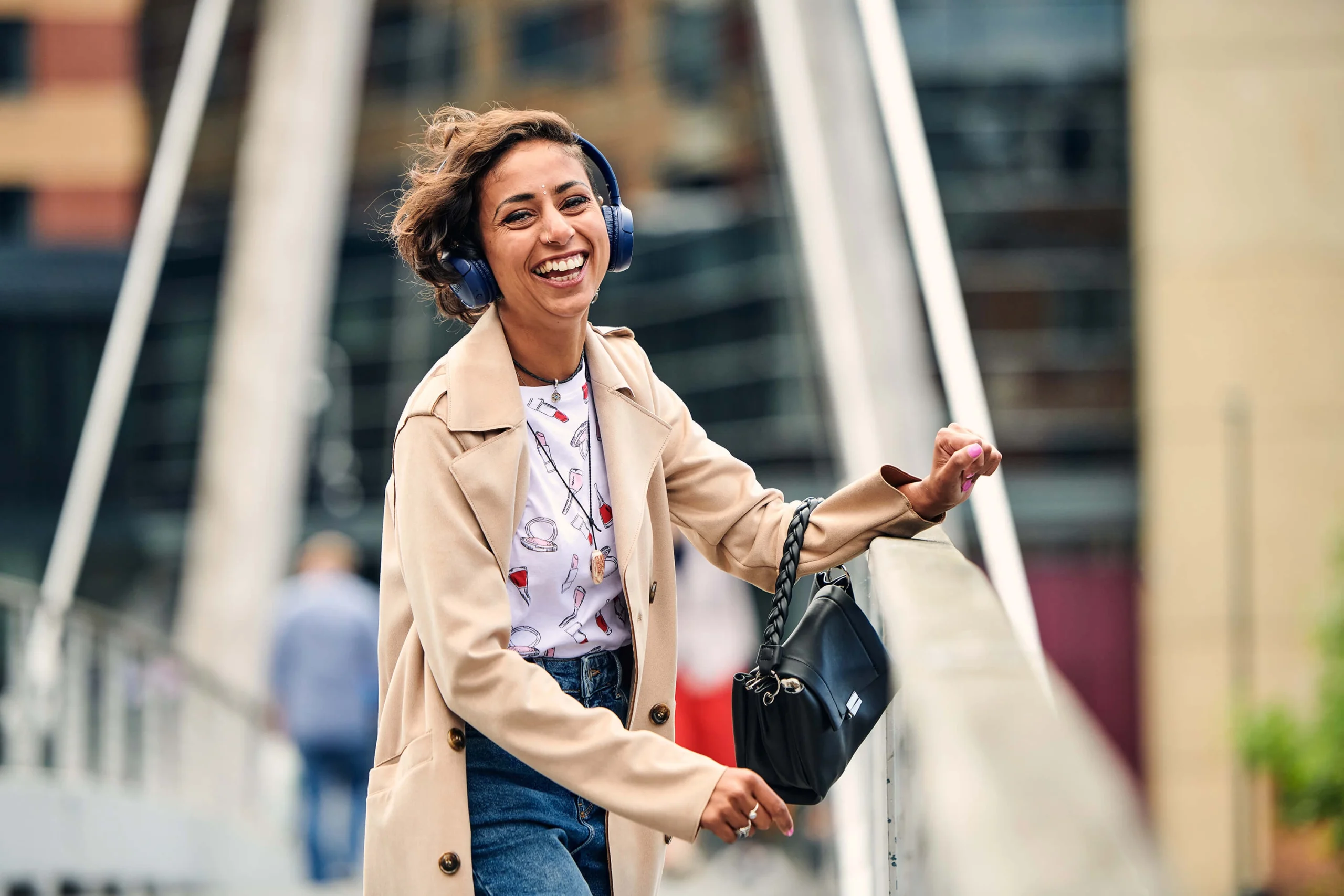 A smiling local woman poses on a bridge