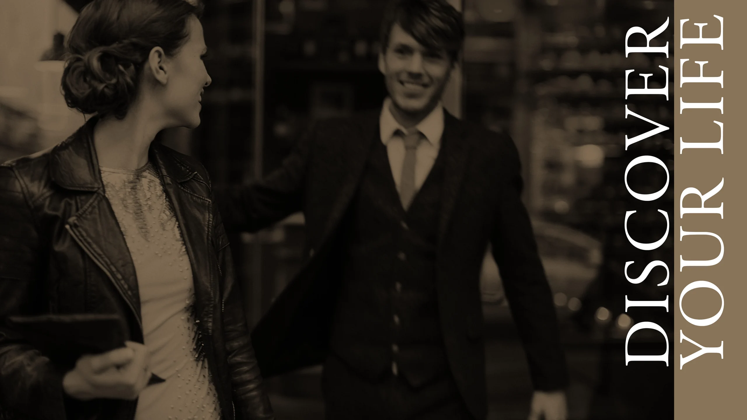 A black and image of a man in his thirties dressed in a suit with a woman in her thirties. Accompanied by the headline "Discover Your Life"