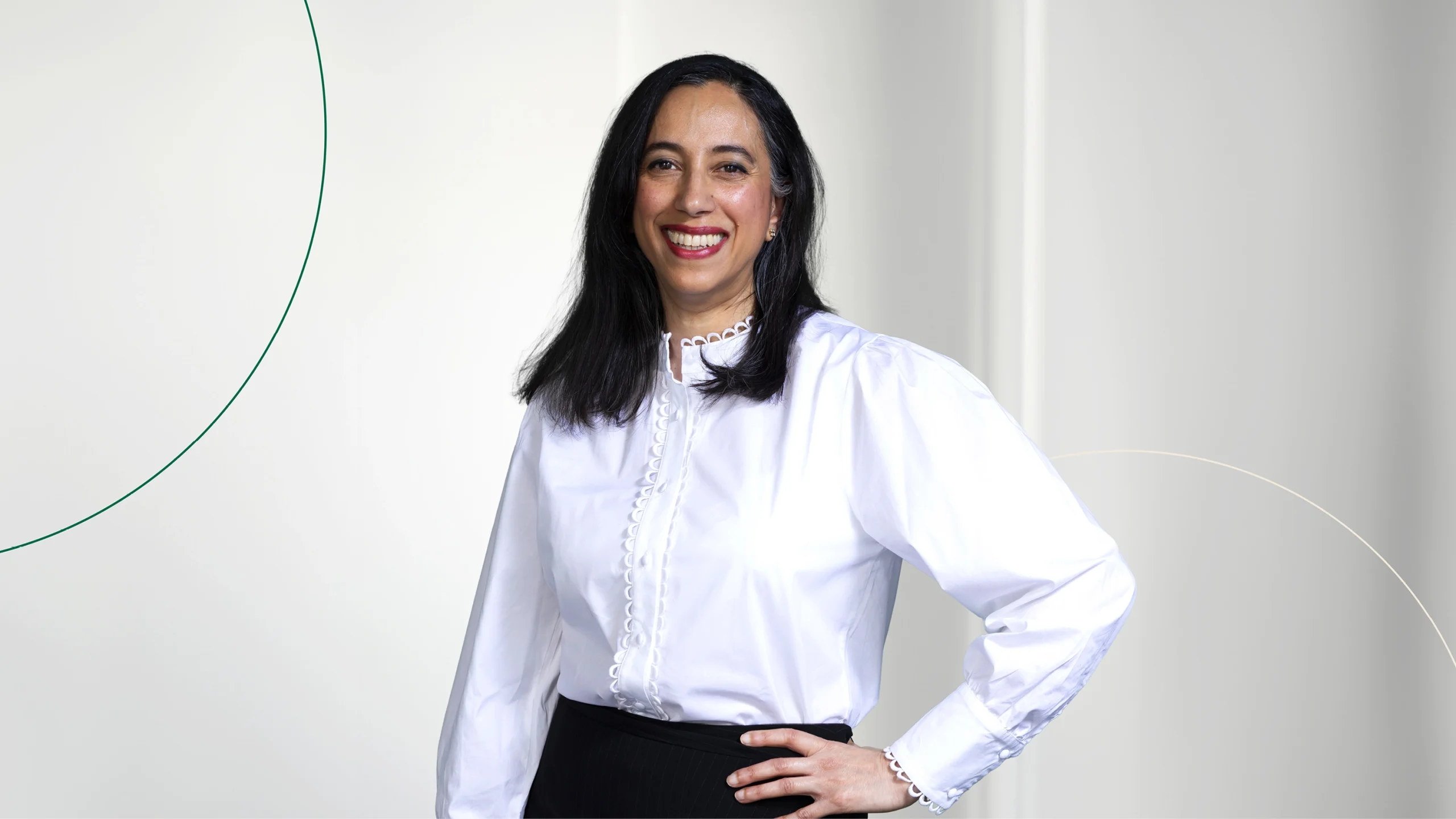 A female J A Kemp employee posing against white background and graphic design elements